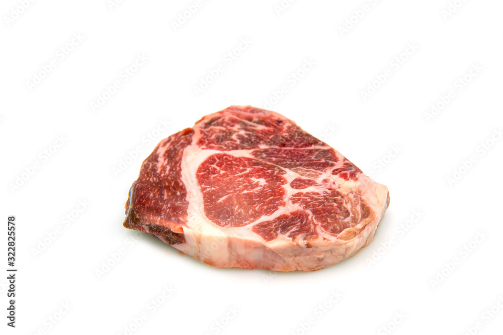 Raw beef rib eye steak on the  white background.