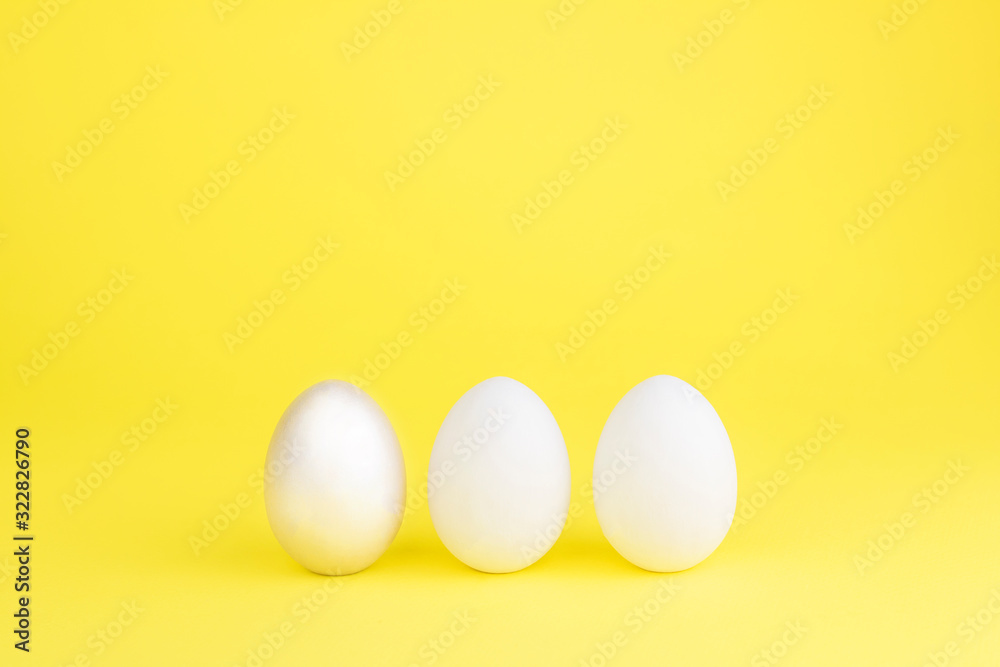 Easter colored bright eggs on a yellow background. Easter creative banner concept card. Copy space Easter colored bright eggs on a yellow background. Easter creative banner concept card. Copy space
