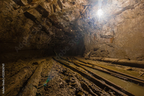 Gold mine underground tunnel with rails