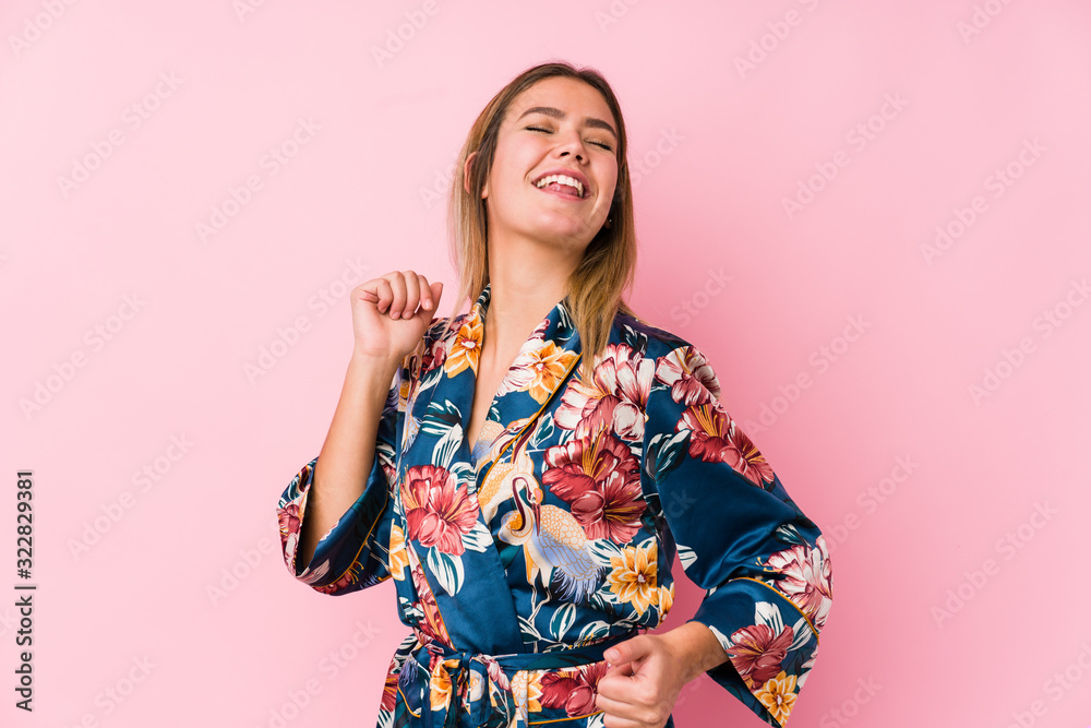 Young caucasian woman wearing pajamas dancing and having fun. Young caucasian woman wearing pajamas dancing and having fun.