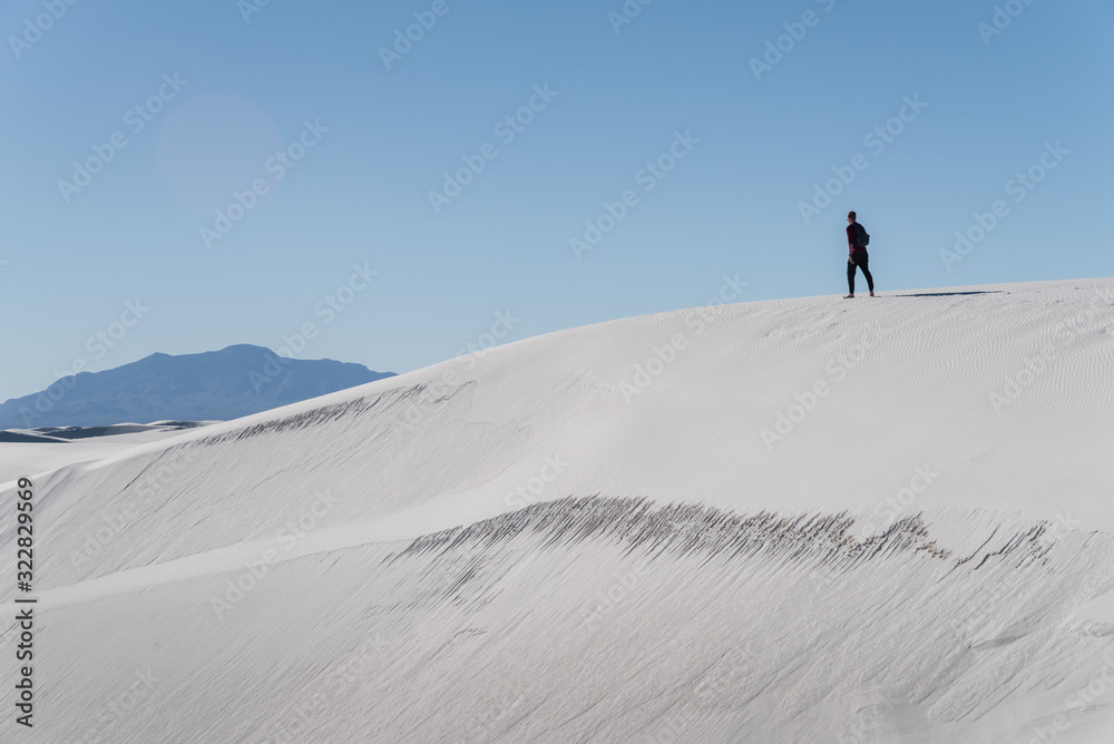 A man walking in the distance at White Sands National Park in Alamogordo, New Mexico. 