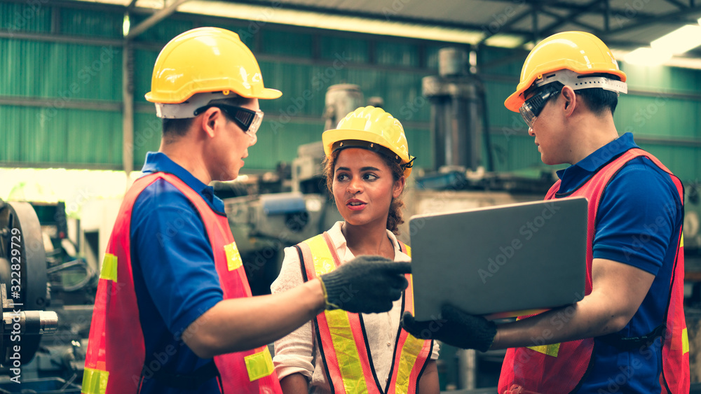 Scene of inspectors team asking information with woman worker and checking the safety and review the function in a factory, concept auditor safety, quality control in a factory, quality inspection.