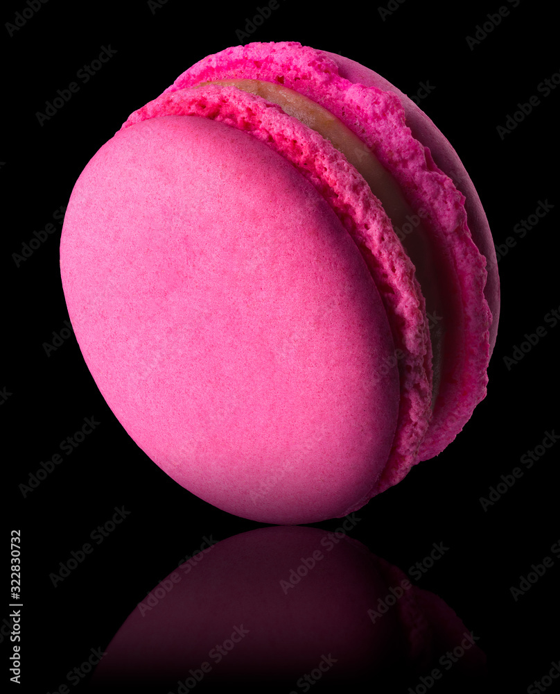 Macro photo of french pink rose macaroon isolated on black with clipping path Macro photo of french pink rose macaroon isolated on black with clipping path