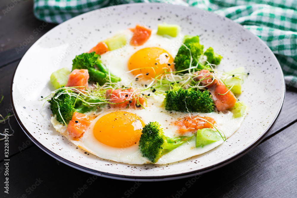 Ketogenic/paleo diet. Fried eggs, salmon, broccoli and microgreen. Keto breakfast. Brunch. Ketogenic/paleo diet. Fried eggs, salmon, broccoli and microgreen. Keto breakfast. Brunch.