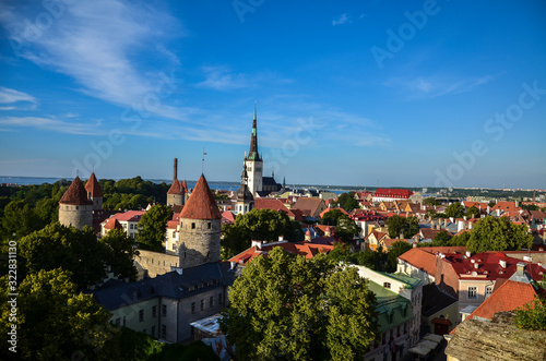 Aerial cityscape with Medieval Old Town, St. Olaf Baptist Church and Tallinn City Wall in the sunny day, Tallinn, Estonia