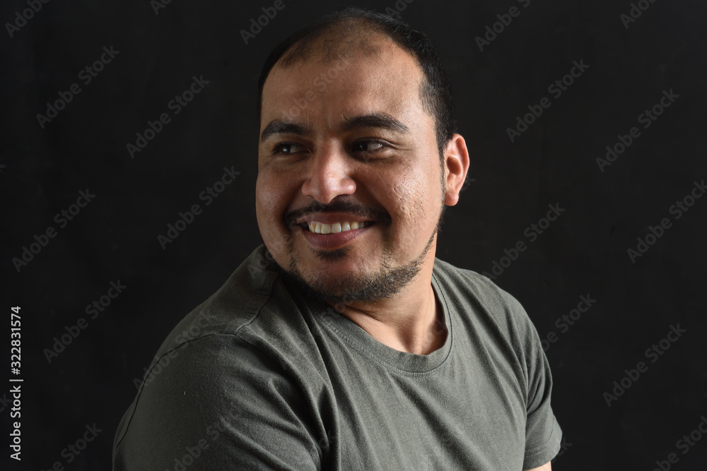 portrait of latin american man looking to the side on black