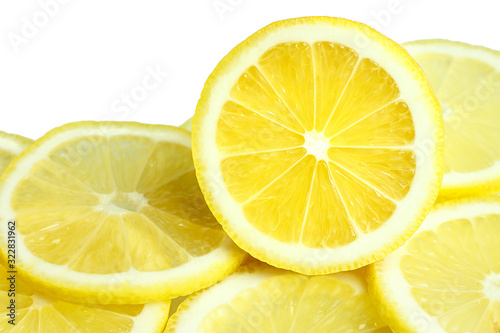 heap of fresh lemon slices on white background