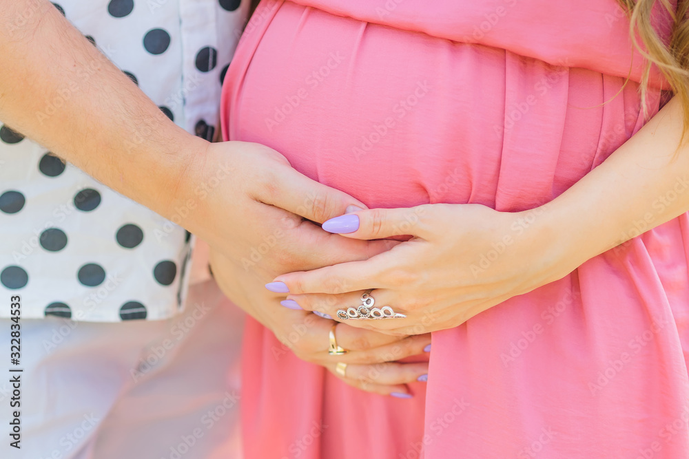 Close up of human hands holding pregnant belly. expectant mother Close up of human hands holding pregnant belly. expectant mother