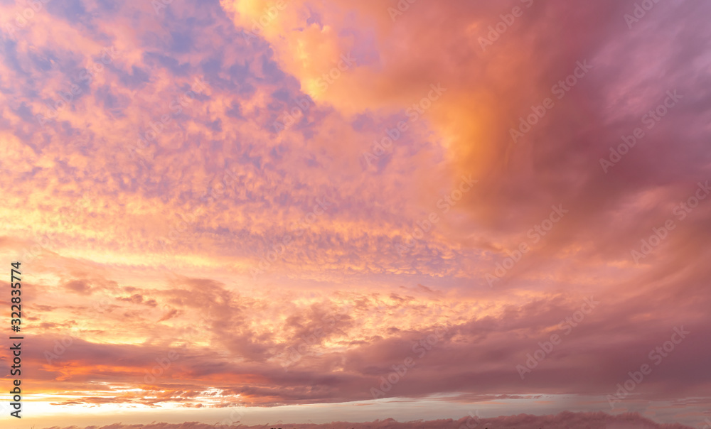 Orange sky with scattered clouds during sunset