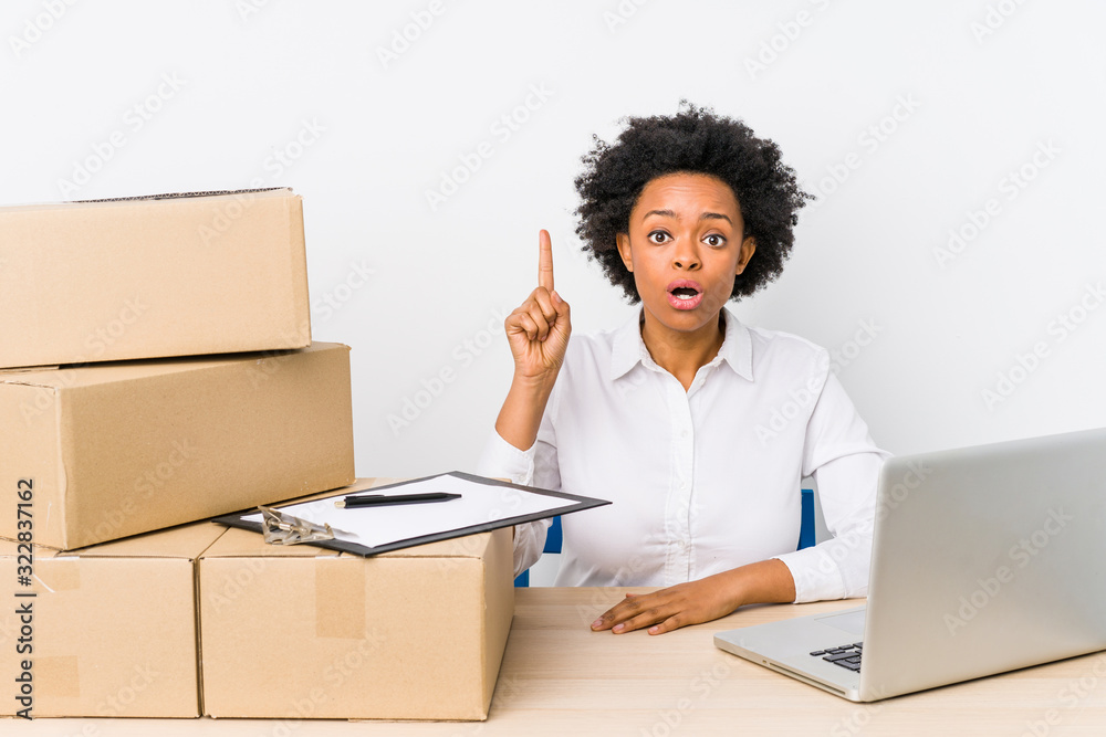 Warehouse manager sitting checking deliveries with laptop having some great idea, concept of creativity. Warehouse manager sitting checking deliveries with laptop having some great idea, concept of creativity.