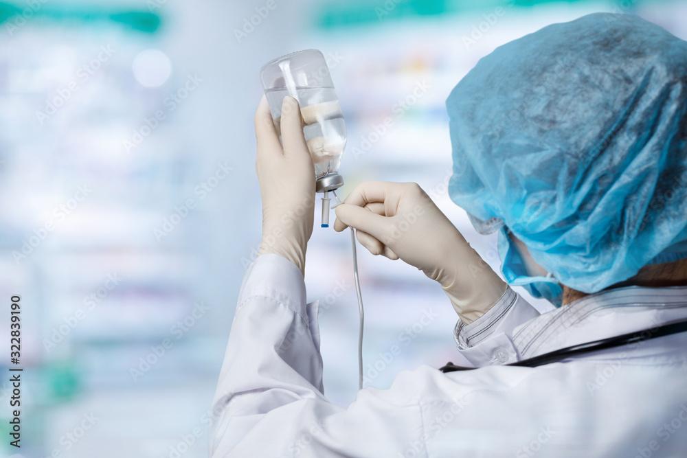 The doctor inserts a needle into a tube of medicine . The doctor inserts a needle into a tube of medicine .