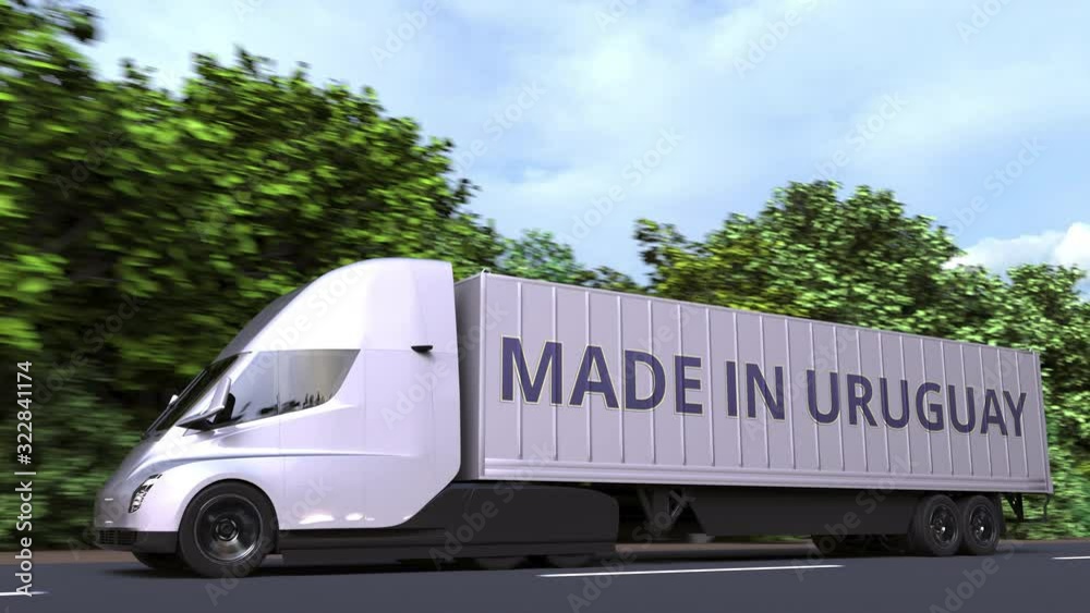 Modern electric semi-trailer truck with MADE IN URUGUAY text on the side. Uruguayan import or export related loopable 3D animation Modern electric semi-trailer truck with MADE IN URUGUAY text on the side. Uruguayan import or export related loopable 3D animation