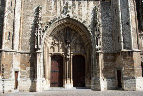 Entrance to the Saint Bavo cathedral in the historic Belgium city of Ghent.  Ornate stone carvings decorate the building.