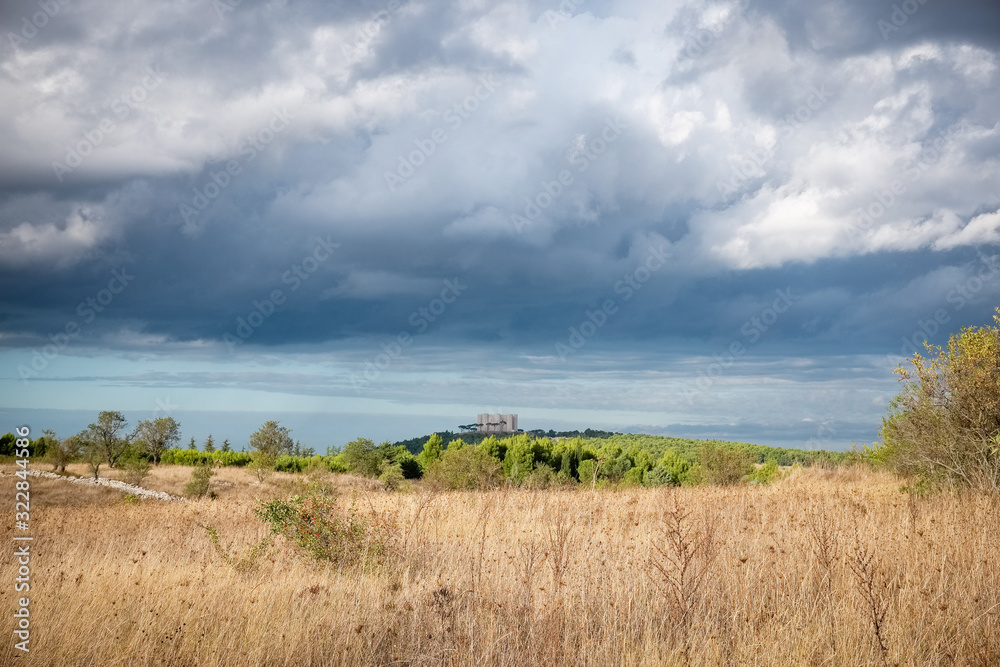 Murgia landscape with Castel del Monte on the background - Apulia, Italy