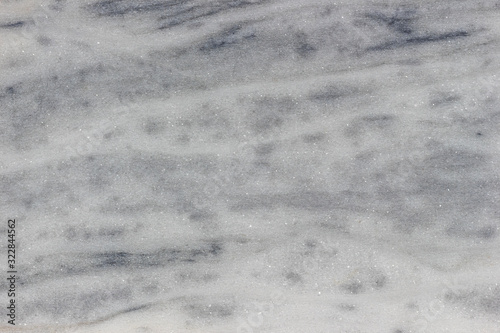 Scratched rough gray marble surface. Grain texture background.