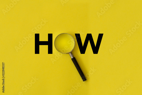 magnifying glass on yellow background, how word photo