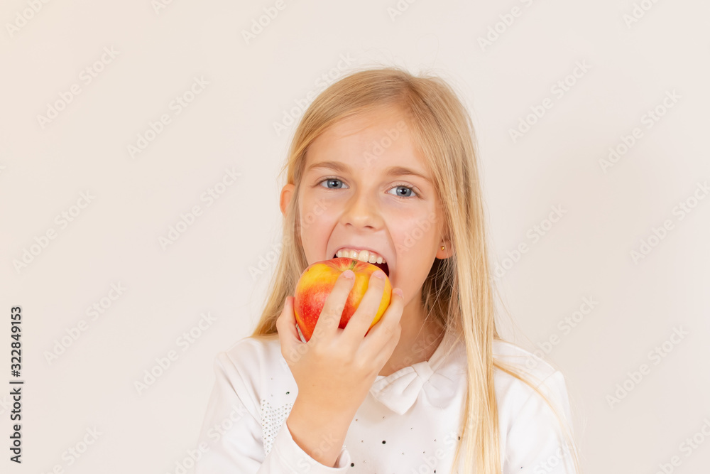 Girl eating an apple with a white t-shirt Girl eating an apple with a white t-shirt