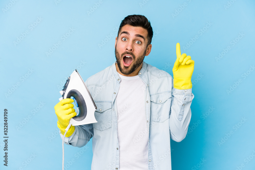 Portrait of young man ironing isolated having an idea, inspiration concept.