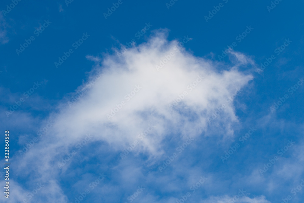 White fluffy clouds in the blue sky White fluffy clouds in the blue sky