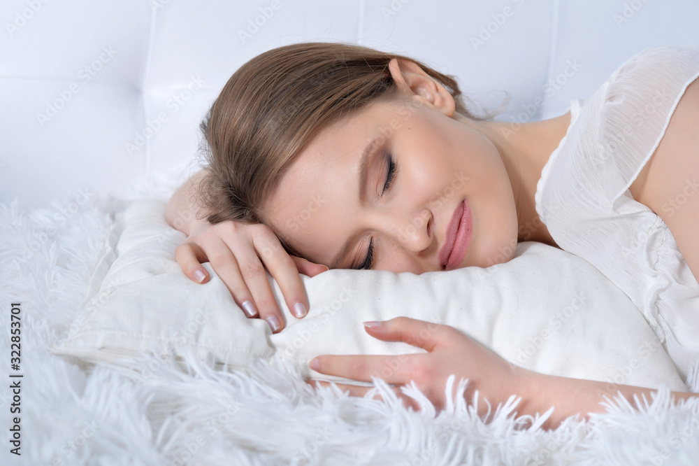 Young woman sleeping in bed at home Young woman sleeping in bed at home