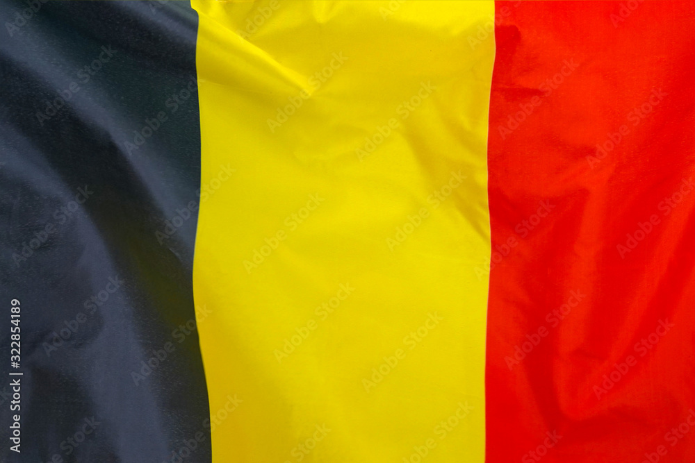 Fabric texture flag of Belgium. Flag of Belgium waving in the wind. Belgium flag is depicted on a sports cloth fabric with many folds. Sport team banner. Fabric texture flag of Belgium. Flag of Belgium waving in the wind. Belgium flag is depicted on a sports cloth fabric with many folds. Sport team banner.