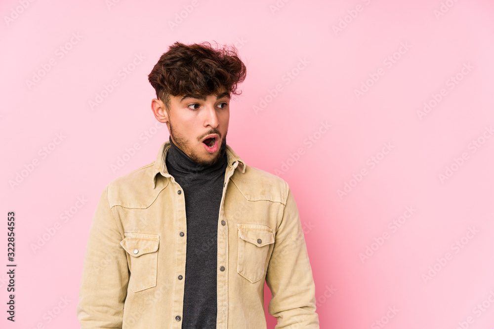 Young arabian man posing in a background isolated being shocked because of something she has seen. Young arabian man posing in a background isolated being shocked because of something she has seen.