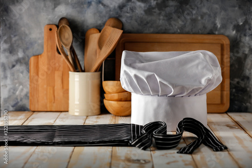 White cook hat in kitchen and free space for your decoration 