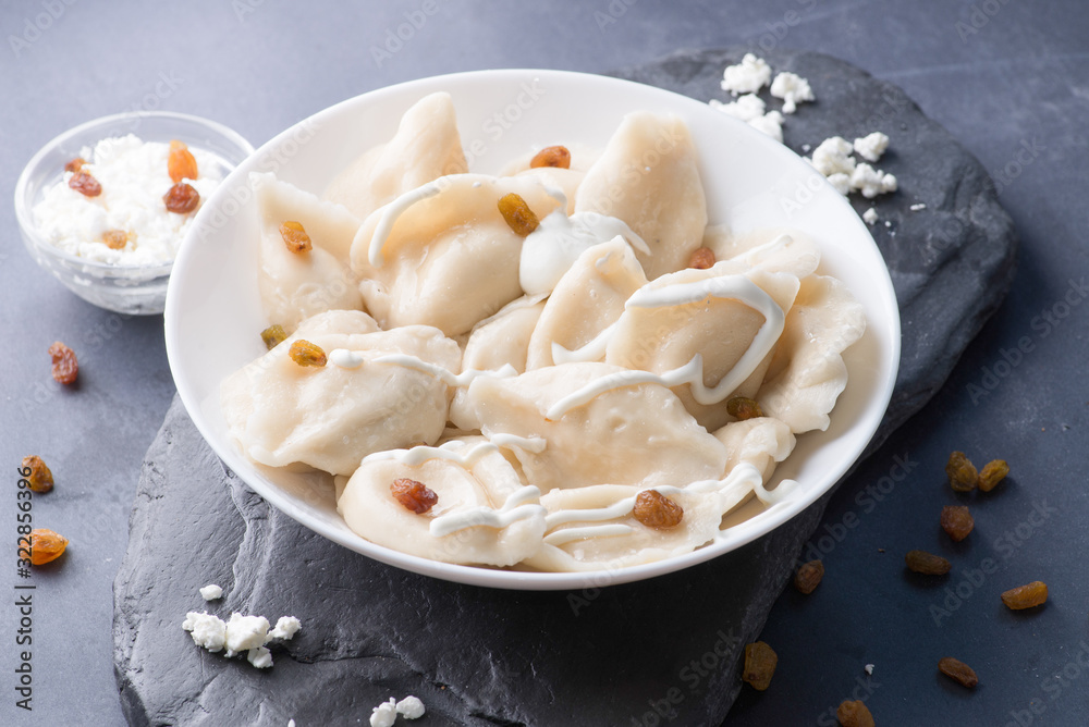 boiled sweet dumplings with filling and sauce on the plate. Steam over a plate boiled sweet dumplings with filling and sauce on the plate. Steam over a plate