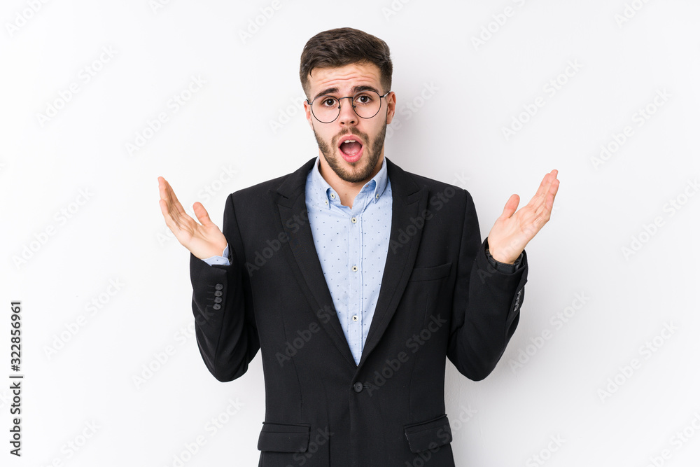 Young caucasian business man posing in a white background isolated Young caucasian business man surprised and shocked. Young caucasian business man posing in a white background isolated Young caucasian business man surprised and shocked.