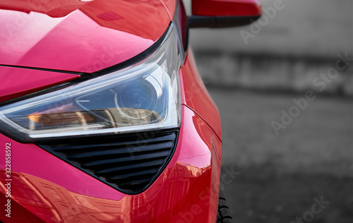 Принти на полотні Headlights and hood of sport red car with silver stars