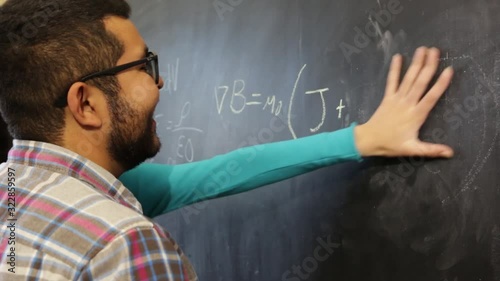 two scientist colleagues revising equations
