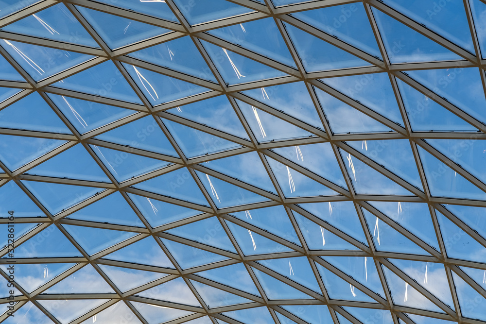 glass ceiling dome in a modern shopping center against a blue sky