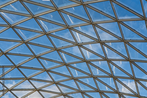 glass ceiling dome in a modern shopping center against a blue sky