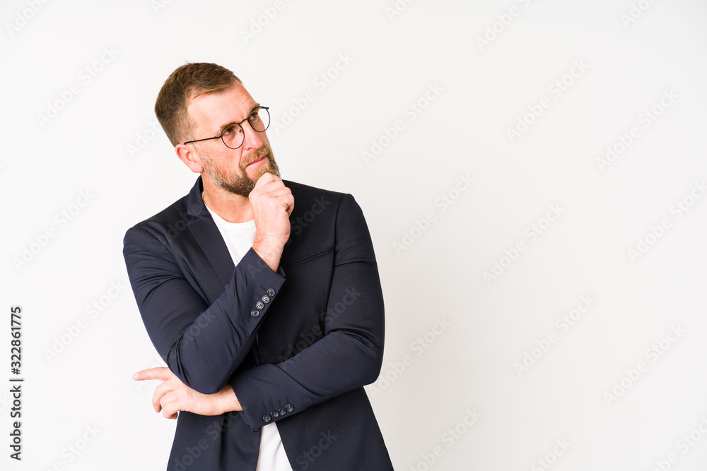 Senior business man isolated on white background looking sideways with doubtful and skeptical expression. Senior business man isolated on white background looking sideways with doubtful and skeptical expression.