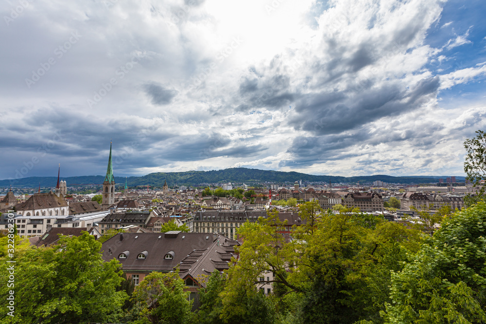 Aerial panorama view of Zurich old town and cityscape from view platform Polyterasse of ETH Zurich on a cloudy summer day, with Uetliberg and TV tower in background, Switzerland