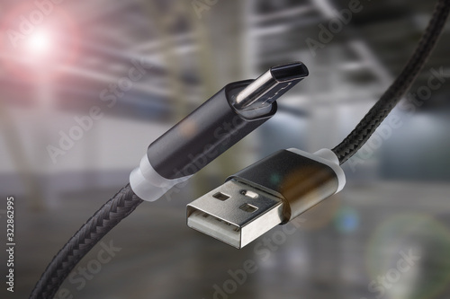 USB cable and USB type-C on an industrial background. photo