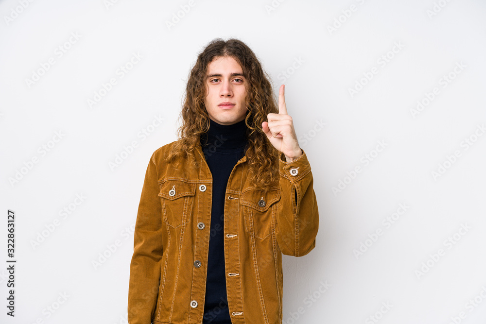 Long hair man posing isolated showing number one with finger. Long hair man posing isolated showing number one with finger.