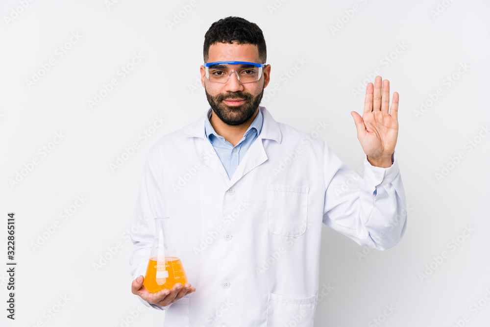 Young arabian chemical man isolated smiling cheerful showing number five with fingers.