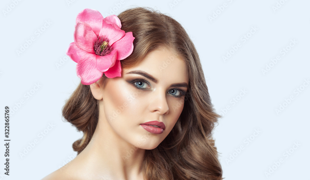 Portrait of a beautiful woman with long eyelashes, beautiful make-up, thick eyebrows and with clean skin in a beauty salon. Eyelash extensions. Face close-up.Makeup and cosmetology concept