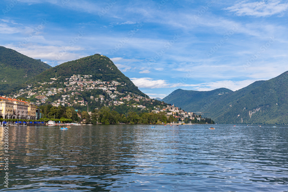 Beautiful  panorama view of Lugano Lake, cityscape of Lugano, mountain Monte Bre and Swiss Alps on a sunny summer day with blue sky cloud, Canton of Ticino, Switzerland