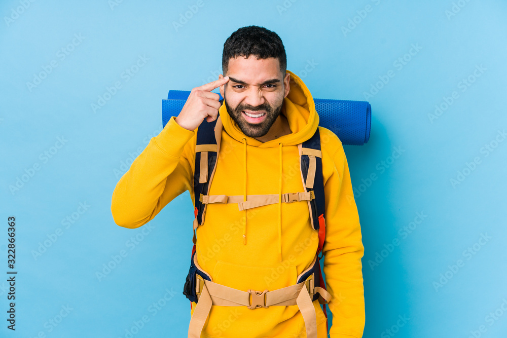 Young arabian traveler backpacker man isolated showing a disappointment gesture with forefinger. Young arabian traveler backpacker man isolated showing a disappointment gesture with forefinger.