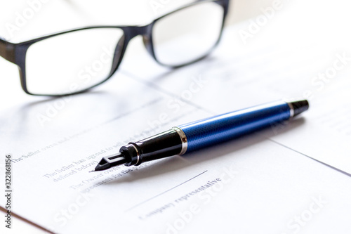 workspace with document, glasses and pen for sign for businessman day