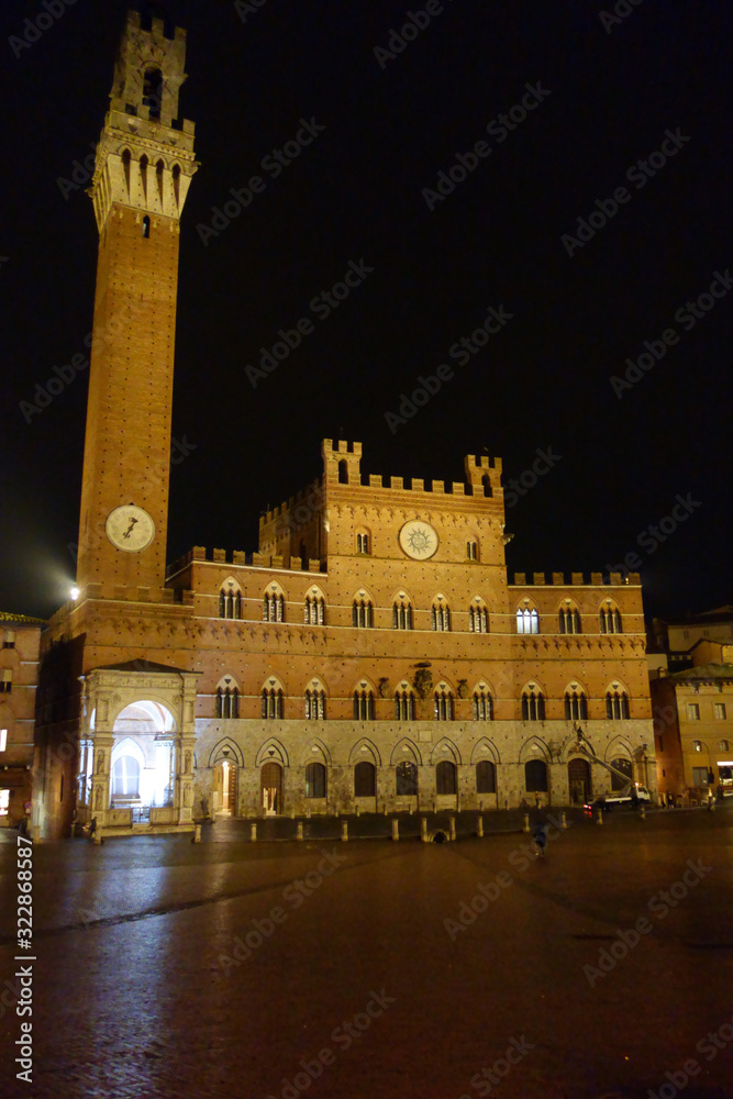 Siena by night. Piazza del Campo and Tower del Mangia illuminated.