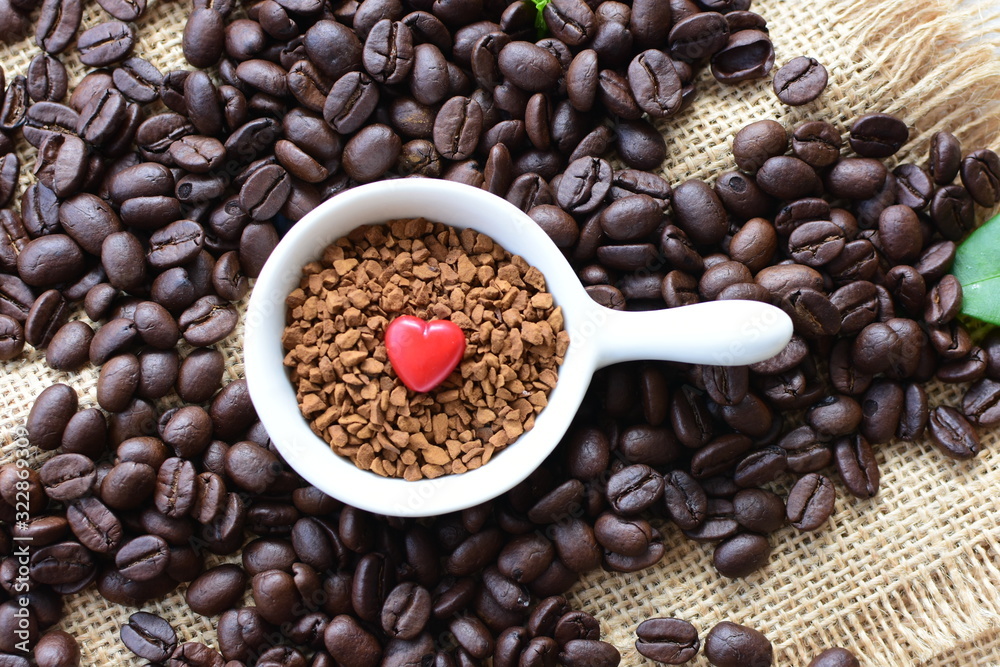 Fototapeta premium Coffee beans, accompanied by processed coffee powder