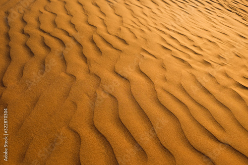 Red and yellow Sands in the RUB al-Khali desert . The texture of sand dunes in the desert is yellow and orange. Waves of sand