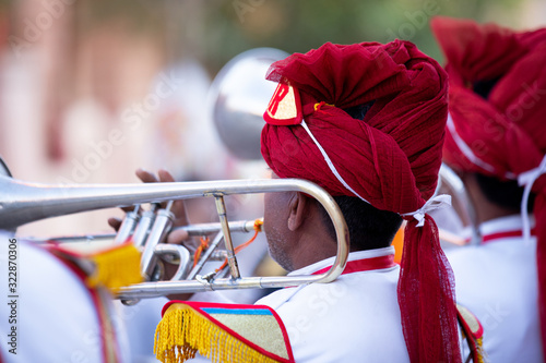 Photography Man Playing trumpet In Indian Wedding Wearing Colorful Dress