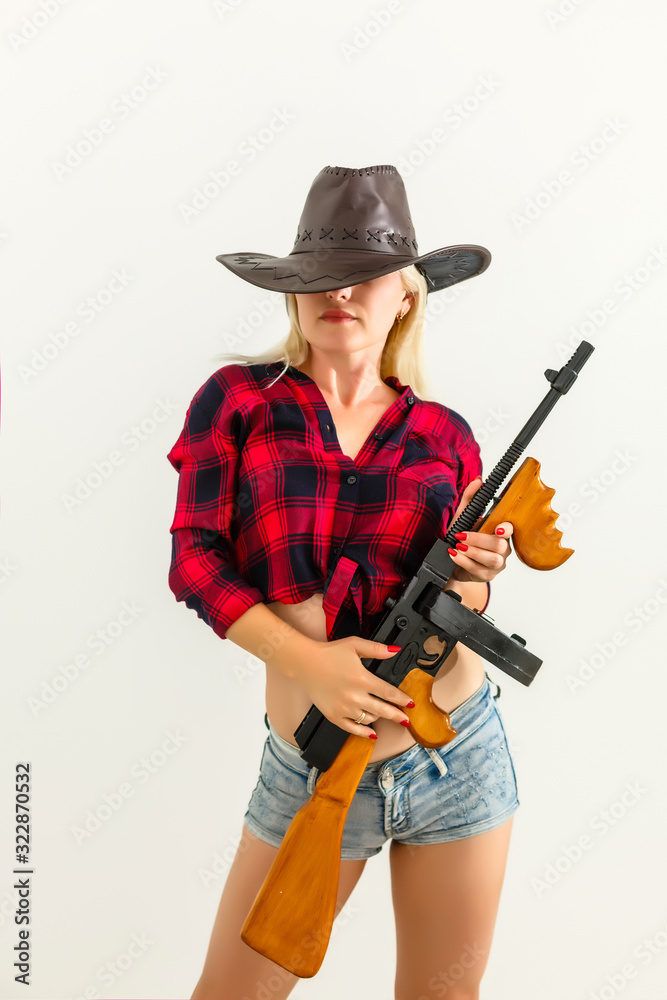 The sexy blonde woman with a hat woman cowboy on a white background The sexy blonde woman with a hat woman cowboy on a white background