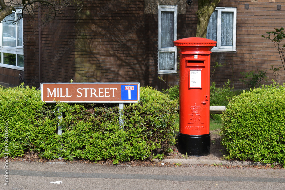 Street Sign & Red Posting Box at side of Road between Green Hedge Street Sign & Red Posting Box at side of Road between Green Hedge