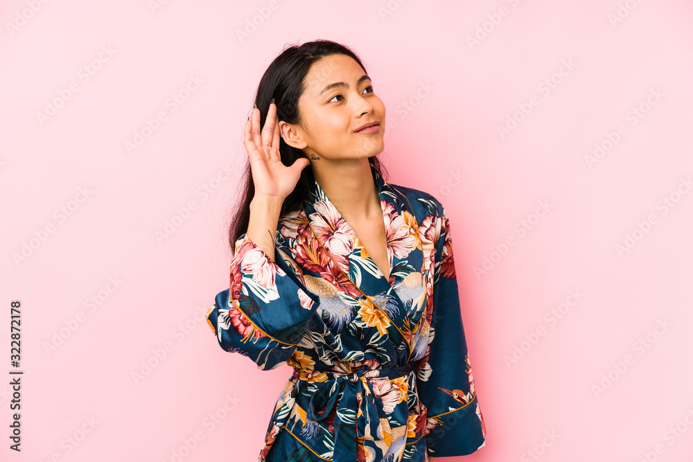 Young chinese woman wearing a asiatic pijama isolated being shocked, she has remembered important meeting. Young chinese woman wearing a asiatic pijama isolated being shocked, she has remembered important meeting.