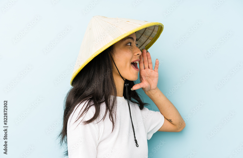 Young chinese woman wearing a vietnamese hay isolated cheerful and confident showing ok gesture. Young chinese woman wearing a vietnamese hay isolated cheerful and confident showing ok gesture.
